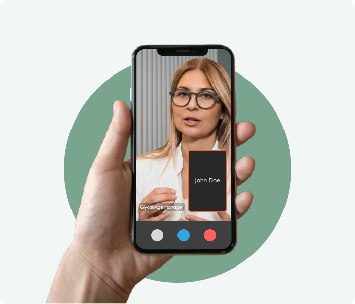 Hand holding a smartphone showing a video consultation with a healthcare professional.